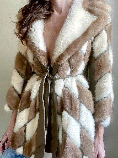 Vintage patchwork fur with leather trim circa 1970s. The belt goes through holes on the sides of the jacket and ties in front. Small. 