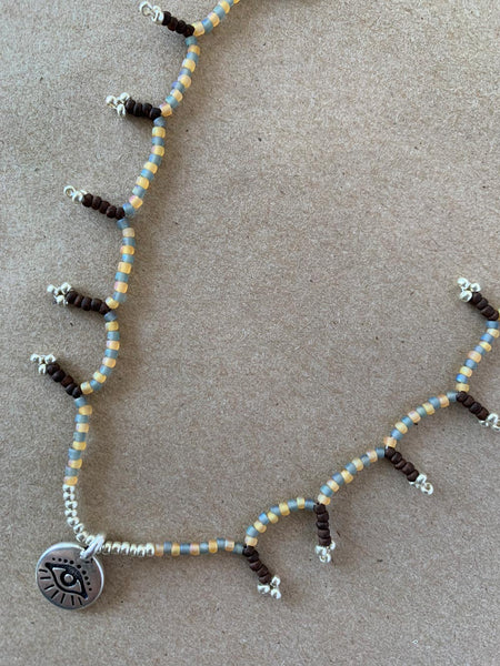 Hand beaded charm necklace.